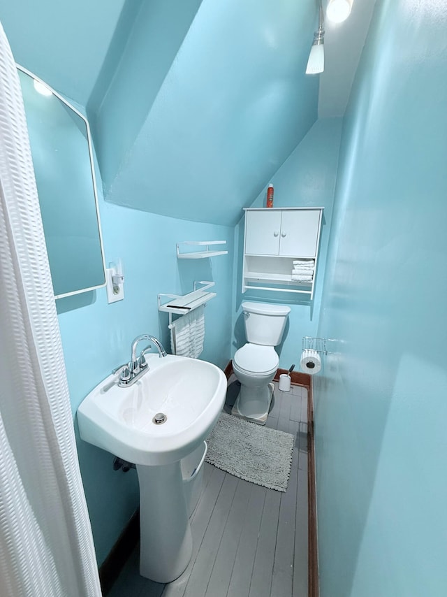 3628 Rau Rd, West Branch, MI 48661 - bathroom with lofted ceiling and wood finished floors