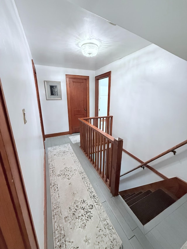 3628 Rau Rd, West Branch, MI 48661 - stairs featuring wood finished floors and baseboards