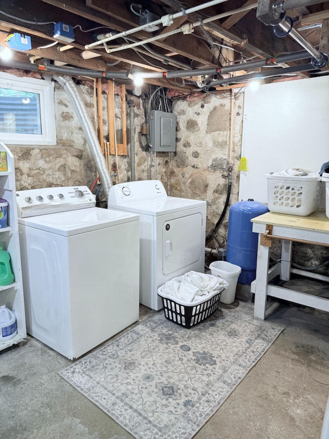3628 Rau Rd, West Branch, MI 48661 - unfinished basement featuring washer and dryer, a water pressure tank, and electric panel