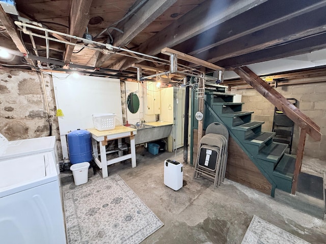 3628 Rau Rd, West Branch, MI 48661 - unfinished below grade area with a water pressure tank, washer and dryer, a workshop area, and stairway