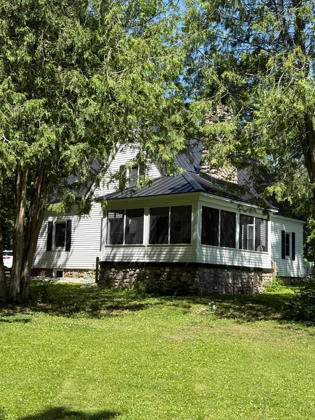 3628 Rau Rd, West Branch, MI 48661 - view of front of property with a sunroom and a front lawn