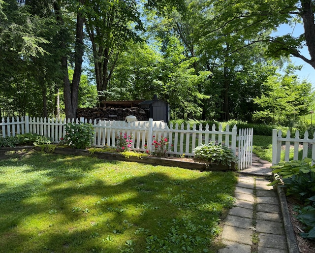 3628 Rau Rd, West Branch, MI 48661 - fenced yard featuring a storage unit