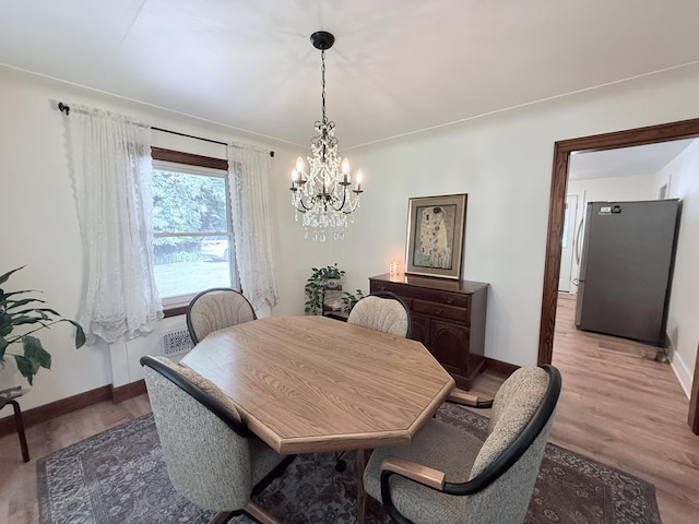 3628 Rau Rd, West Branch, MI 48661 - dining area featuring a chandelier and light wood finished floors