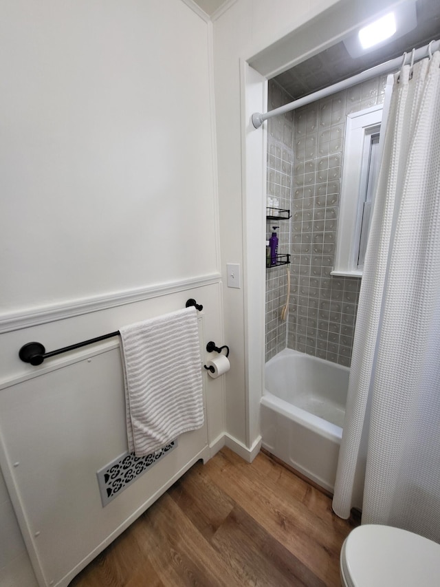 3628 Rau Rd, West Branch, MI 48661 - bathroom featuring wood finished floors and shower / tub combo