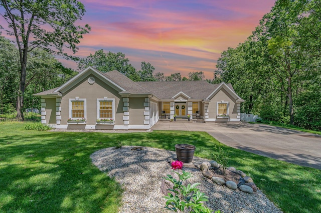 118 Frisco Dr, Houghton Lake, MI 48629 - ranch-style home with a lawn and stucco siding