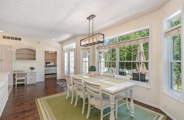 118 Frisco Dr, Houghton Lake, MI 48629 - dining space with a chandelier and dark wood finished floors