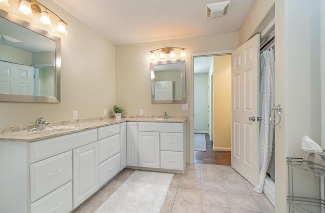 118 Frisco Dr, Houghton Lake, MI 48629 - bathroom featuring double vanity, tile patterned flooring, and curtained shower