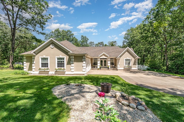 118 Frisco Dr, Houghton Lake, MI 48629 - ranch-style home featuring stucco siding, a front lawn, and french doors