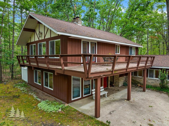 2801 Cobb Rd, Lewiston, MI 49756 - back of house with a patio area, a chimney, a deck, and a shingled roof