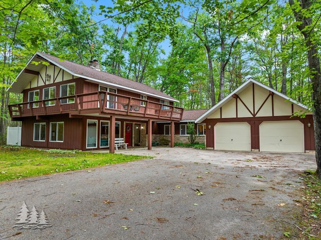 2801 Cobb Rd, Lewiston, MI 49756 - view of front of home with driveway, a chimney, an attached garage, and a deck