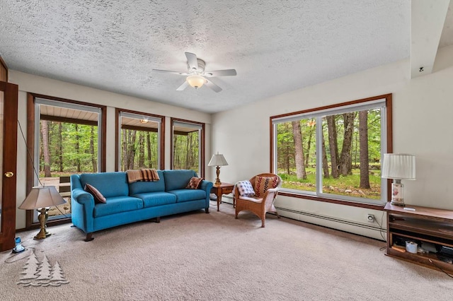 2801 Cobb Rd, Lewiston, MI 49756 - carpeted living room with ceiling fan, plenty of natural light, a textured ceiling, and a baseboard heating unit
