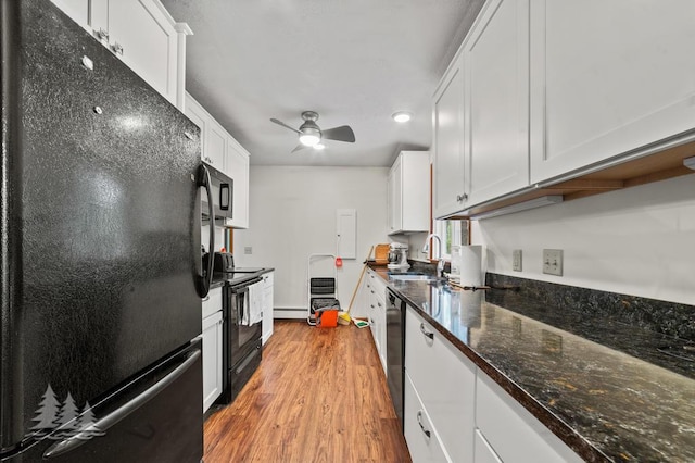 2801 Cobb Rd, Lewiston, MI 49756 - kitchen with black appliances, light wood finished floors, white cabinets, ceiling fan, and baseboard heating