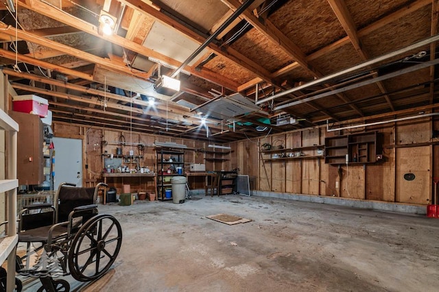 2801 Cobb Rd, Lewiston, MI 49756 - garage with a workshop area and a garage door opener