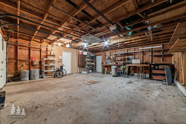 2801 Cobb Rd, Lewiston, MI 49756 - garage with a workshop area and a garage door opener