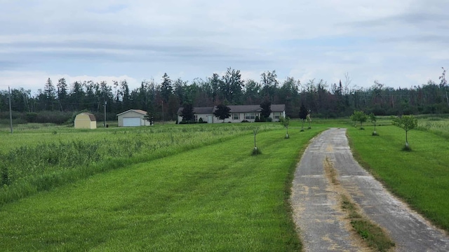 15135 M-32, Lachine, MI 49753 - view of dirt / gravel driveway featuring a rural view and a forest view