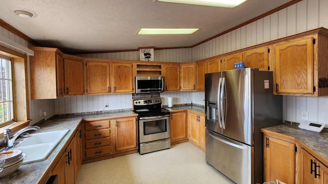 15135 M-32, Lachine, MI 49753 - kitchen with appliances with stainless steel finishes, brown cabinets, ornamental molding, a textured ceiling, and vaulted ceiling