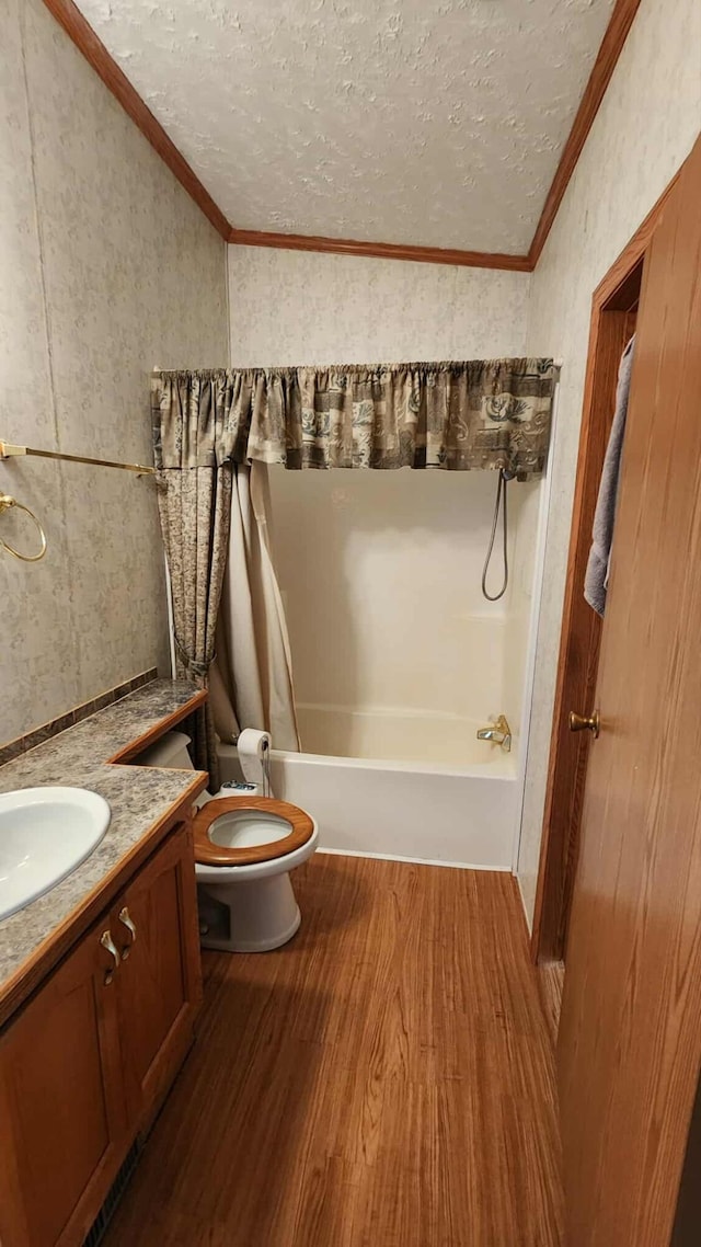 15135 M-32, Lachine, MI 49753 - bathroom with a textured ceiling, vanity, ornamental molding, wood finished floors, and shower / washtub combination