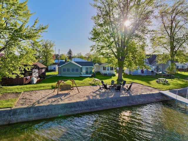 6390 W Houghton Lake Dr, Houghton Lake, MI 48629 - dock area featuring a yard, a water view, and a fire pit