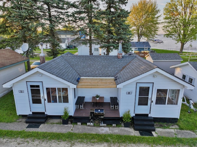 6390 W Houghton Lake Dr, Houghton Lake, MI 48629 - back of house with entry steps, a wooden deck, and a shingled roof