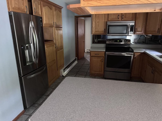 3011 Piper Rd, Alpena, MI 49707 - kitchen with appliances with stainless steel finishes, tile patterned floors, a baseboard heating unit, and light countertops