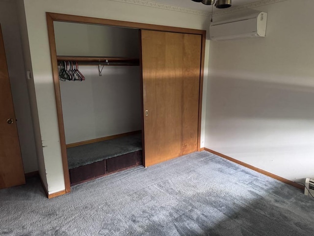 3011 Piper Rd, Alpena, MI 49707 - unfurnished bedroom featuring carpet floors, a wall unit AC, and a closet