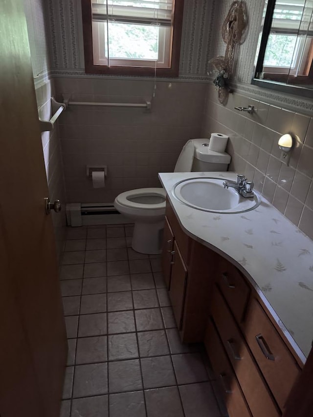 3011 Piper Rd, Alpena, MI 49707 - bathroom with tile walls, a baseboard heating unit, vanity, tile patterned floors, and wainscoting