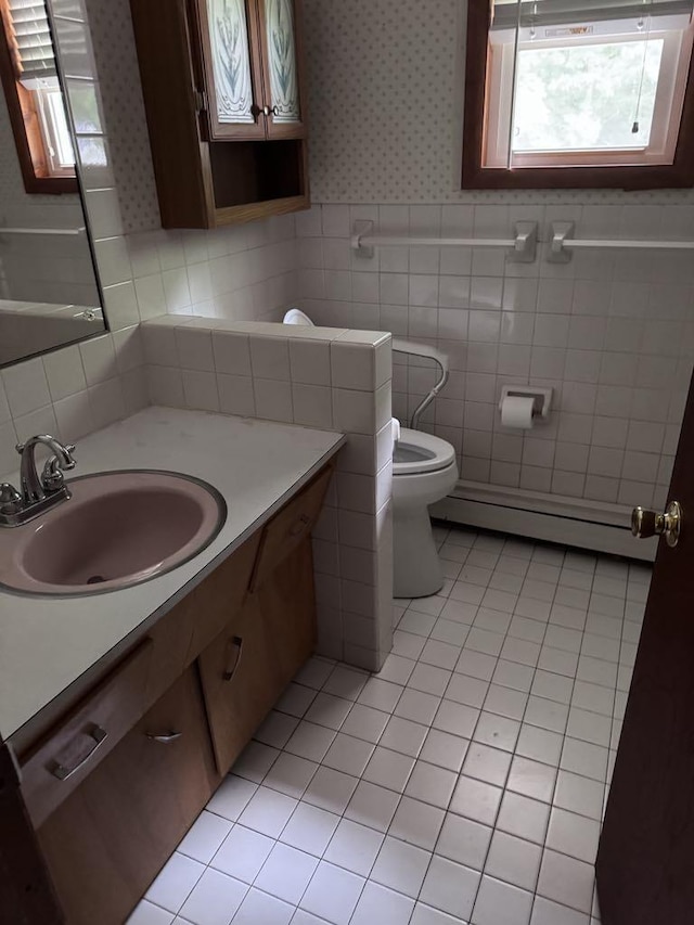 3011 Piper Rd, Alpena, MI 49707 - bathroom featuring wallpapered walls, a baseboard heating unit, vanity, and tile patterned flooring
