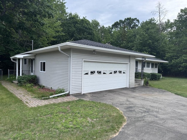 3011 Piper Rd, Alpena, MI 49707 - view of front facade with driveway, a front lawn, and an attached garage