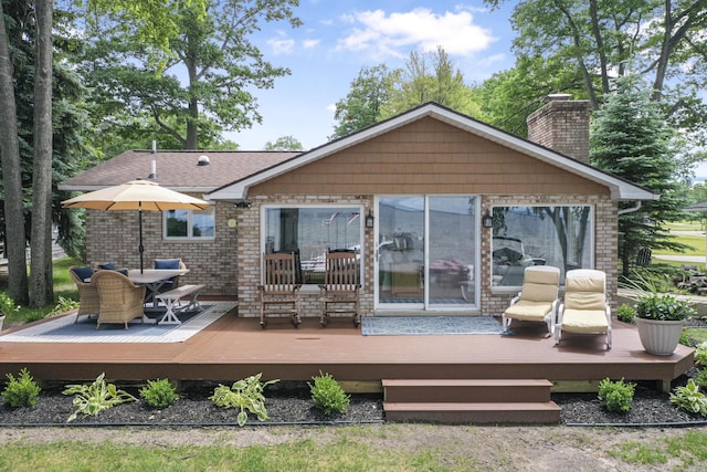 802 Houghton View Dr, Prudenville, MI 48651 - back of house with a chimney and a deck