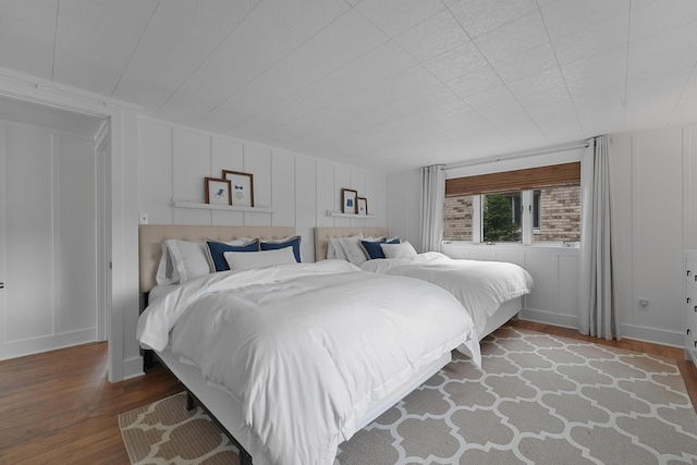 802 Houghton View Dr, Prudenville, MI 48651 - bedroom with a decorative wall and wood finished floors