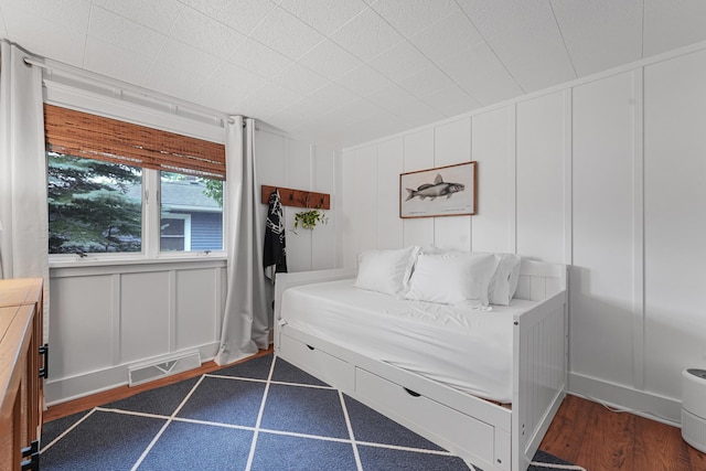 802 Houghton View Dr, Prudenville, MI 48651 - bedroom featuring a decorative wall and dark wood finished floors