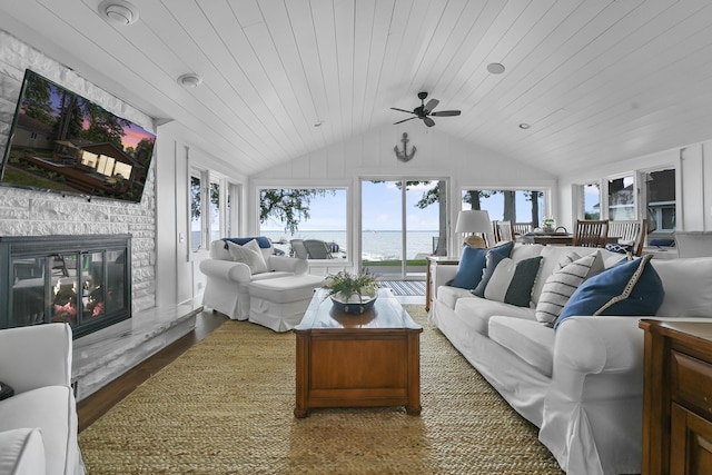 802 Houghton View Dr, Prudenville, MI 48651 - living area with lofted ceiling, a ceiling fan, a water view, a fireplace, and wood finished floors
