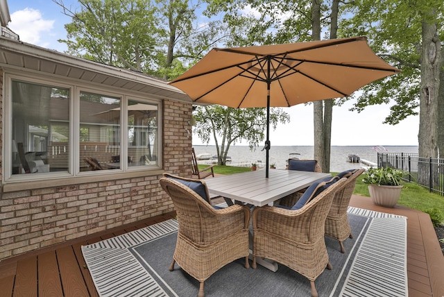 802 Houghton View Dr, Prudenville, MI 48651 - wooden terrace with a water view and outdoor dining area