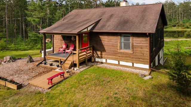 6612 Old Vanderbilt Rd, Vanderbilt, MI 49795 - view of front of property featuring a chimney, a front lawn, a deck, and a shingled roof