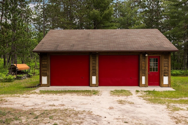 6612 Old Vanderbilt Rd, Vanderbilt, MI 49795 - detached garage featuring view of scattered trees