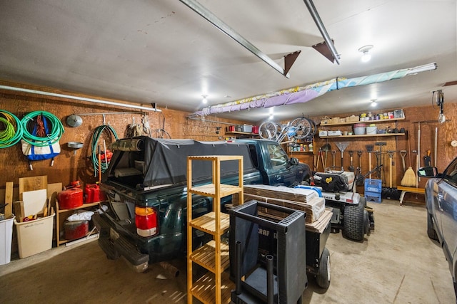 6612 Old Vanderbilt Rd, Vanderbilt, MI 49795 - garage with wooden walls and a workshop area