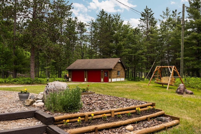 6612 Old Vanderbilt Rd, Vanderbilt, MI 49795 - view of grassy yard with a garage, an outbuilding, and a playground