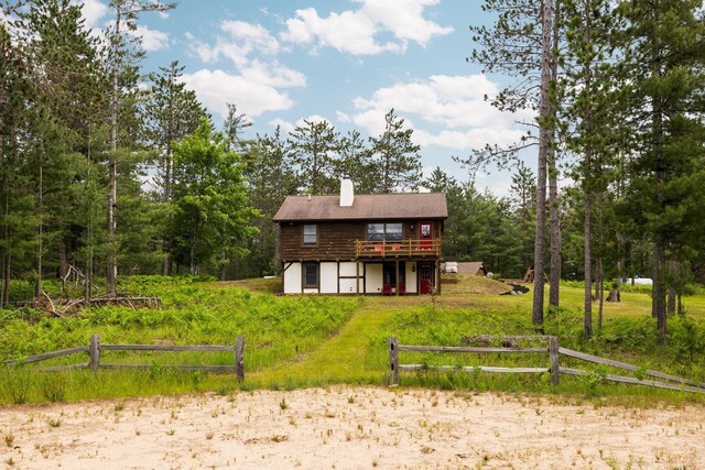 6612 Old Vanderbilt Rd, Vanderbilt, MI 49795 - back of house with a deck and a chimney