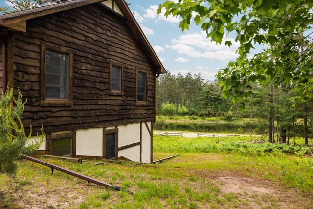 6612 Old Vanderbilt Rd, Vanderbilt, MI 49795 - view of side of home featuring a water view and log exterior