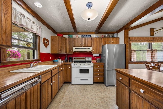 6612 Old Vanderbilt Rd, Vanderbilt, MI 49795 - kitchen featuring white gas range oven, freestanding refrigerator, under cabinet range hood, dishwashing machine, and beam ceiling