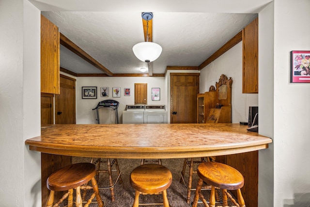 6612 Old Vanderbilt Rd, Vanderbilt, MI 49795 - kitchen featuring washing machine and clothes dryer and a textured ceiling