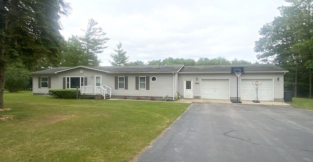 7717 Weiss Rd, Alpena, MI 49707 - single story home featuring an attached garage, driveway, and a front lawn