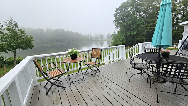7717 Weiss Rd, Alpena, MI 49707 - wooden deck featuring a water view and outdoor dining space