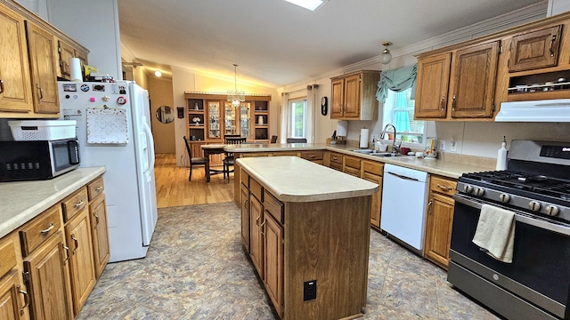 7717 Weiss Rd, Alpena, MI 49707 - kitchen with appliances with stainless steel finishes, a peninsula, a center island, light countertops, and ornamental molding