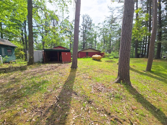 2880 Ann Arbor Rd, Lewiston, MI 49756 - view of yard featuring a pole building, a carport, and an outdoor structure