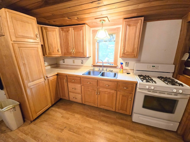 2880 Ann Arbor Rd, Lewiston, MI 49756 - kitchen with white range with gas stovetop, light wood-style floors, wooden ceiling, light countertops, and decorative light fixtures