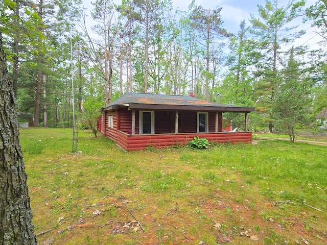 2880 Ann Arbor Rd, Lewiston, MI 49756 - rear view of property with a yard