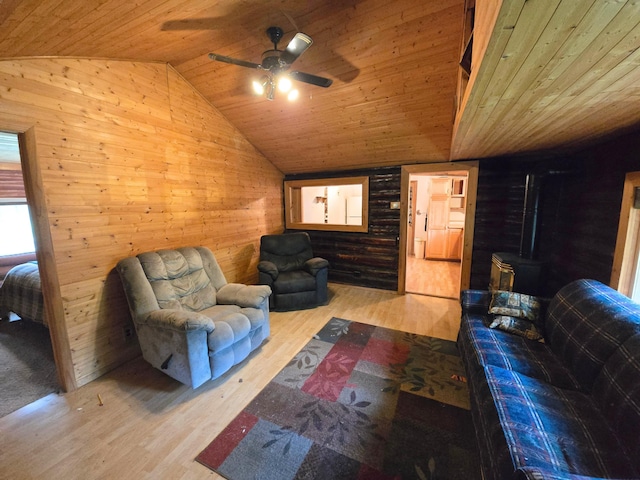 2880 Ann Arbor Rd, Lewiston, MI 49756 - living room with vaulted ceiling, wood walls, wood ceiling, wood finished floors, and a ceiling fan