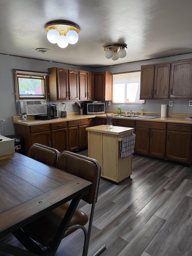 2493 S Horseshoe Trl, Grayling, MI 49738 - kitchen with light countertops, stainless steel microwave, dark wood-style flooring, cooling unit, and a kitchen island