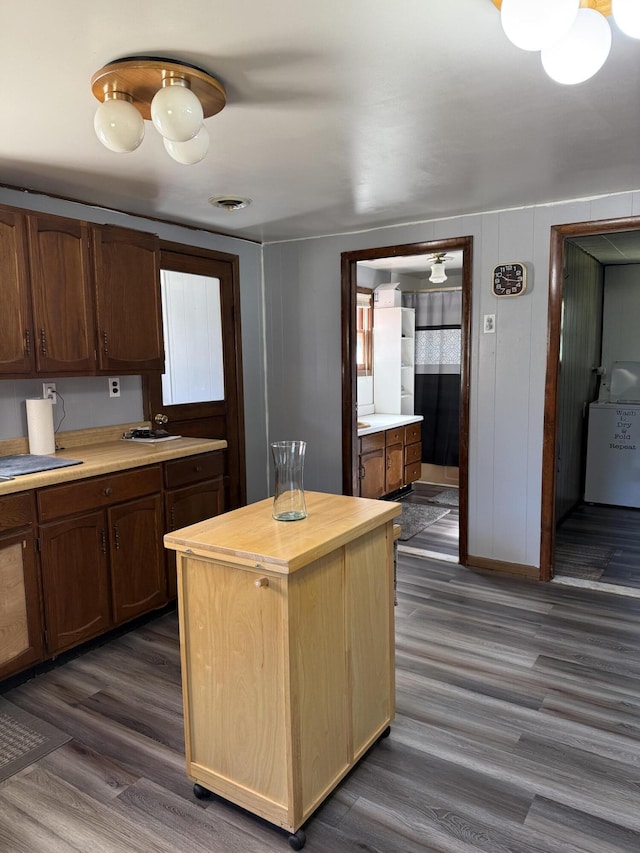 2493 S Horseshoe Trl, Grayling, MI 49738 - kitchen with wooden counters, dark wood-style flooring, and washer / dryer